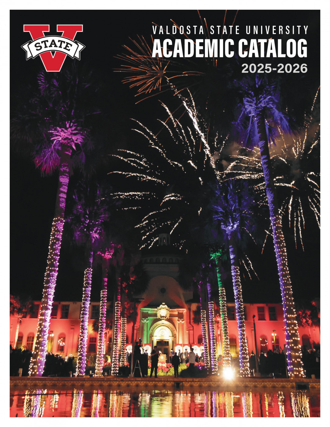 fireworks seen through the palms lining the walkway in front of west hall